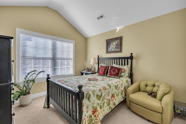 bedroom featuring light colored carpet and vaulted ceiling