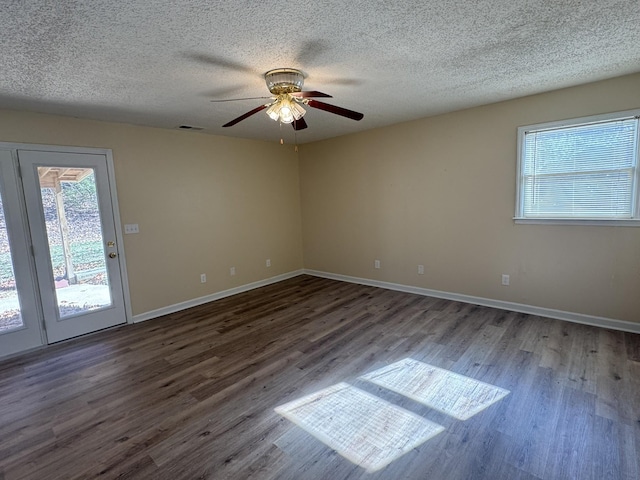 spare room featuring ceiling fan, dark hardwood / wood-style flooring, and a textured ceiling