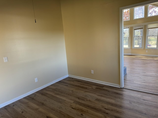 spare room with dark hardwood / wood-style floors