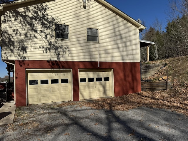 view of side of home featuring a garage