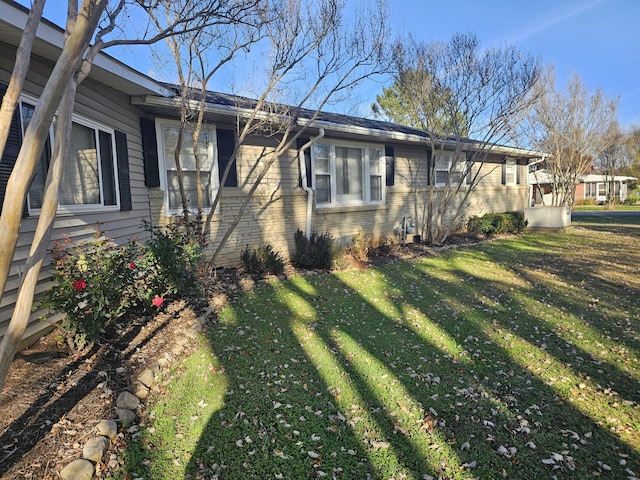 view of side of property with a yard