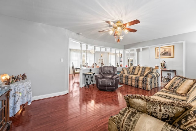 living room with dark hardwood / wood-style floors and ceiling fan