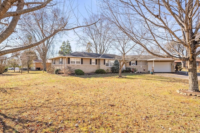 ranch-style house featuring a garage and a front lawn