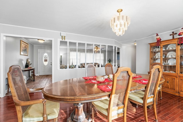 dining space featuring dark hardwood / wood-style floors and an inviting chandelier