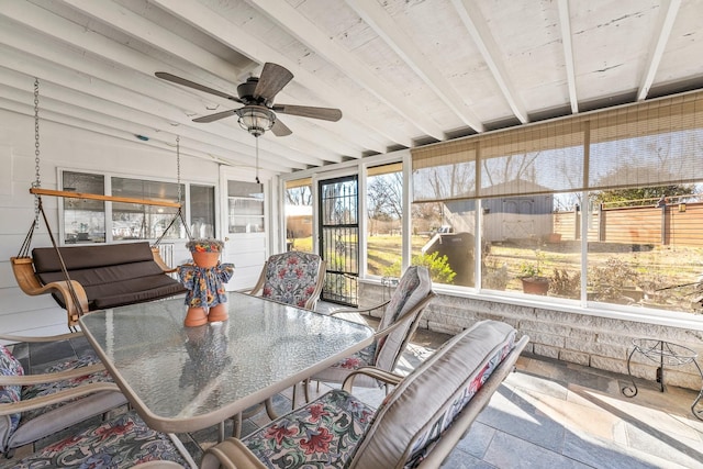 sunroom / solarium with ceiling fan and lofted ceiling