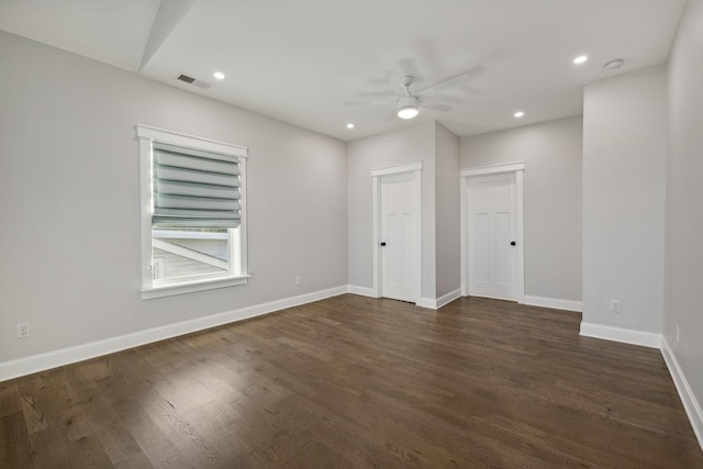 empty room with ceiling fan and dark hardwood / wood-style floors