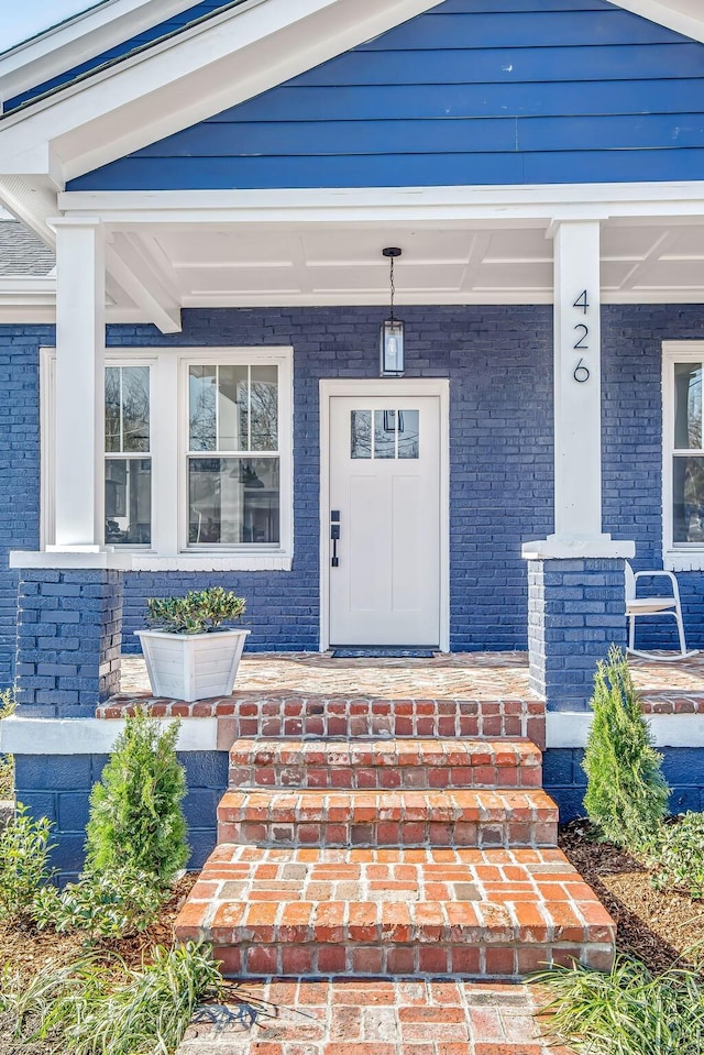 view of exterior entry featuring a porch