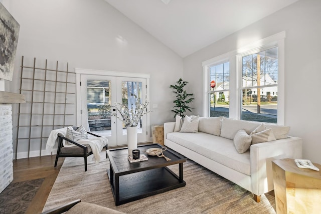 living room featuring french doors, high vaulted ceiling, and hardwood / wood-style floors