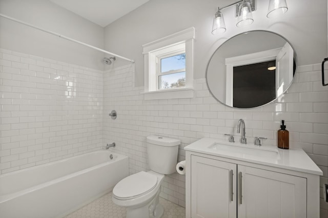 full bathroom with tiled shower / bath, vanity, tile patterned floors, and tile walls