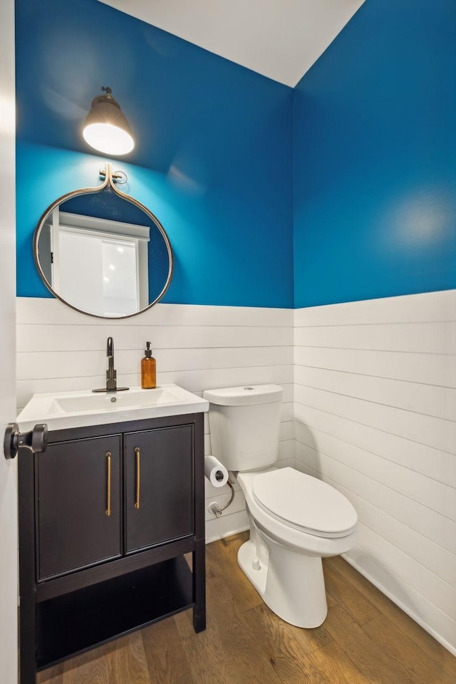 bathroom featuring vanity, hardwood / wood-style floors, and toilet