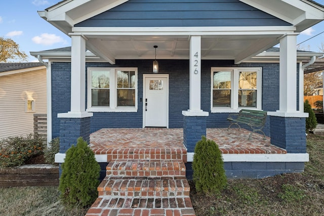 entrance to property featuring covered porch