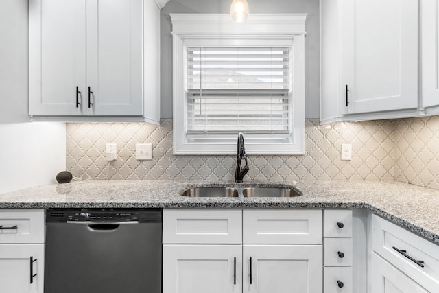 kitchen featuring a sink, backsplash, white cabinets, and stainless steel dishwasher