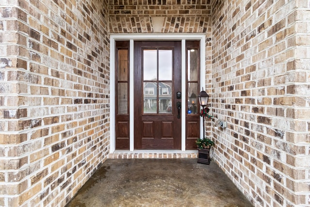 entrance to property with brick siding