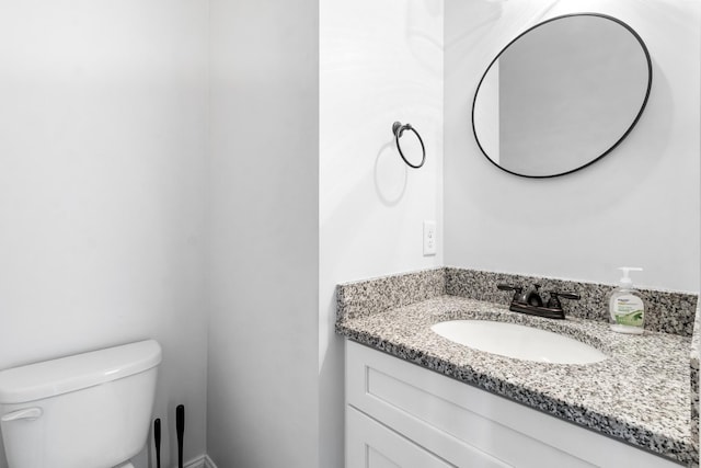 bathroom with toilet and vanity