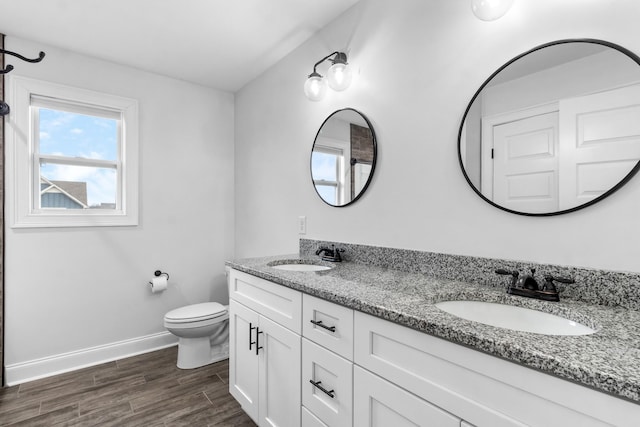 full bath featuring baseboards, a sink, toilet, and wood finished floors