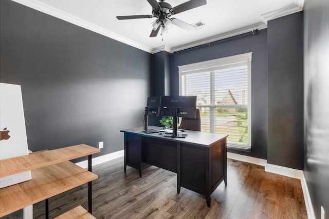 home office featuring baseboards, visible vents, ceiling fan, ornamental molding, and wood finished floors