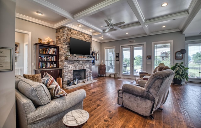 living room with ornamental molding, coffered ceiling, beam ceiling, dark hardwood / wood-style floors, and a stone fireplace