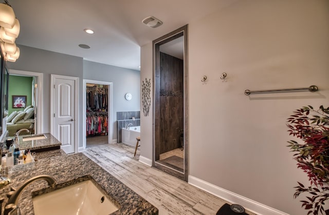 bathroom featuring separate shower and tub, vanity, and hardwood / wood-style flooring