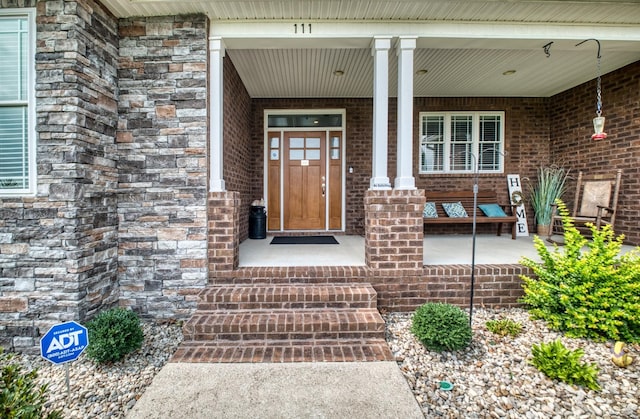 entrance to property featuring covered porch