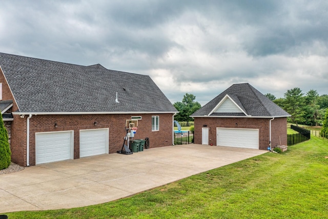 view of home's exterior featuring a garage and a lawn