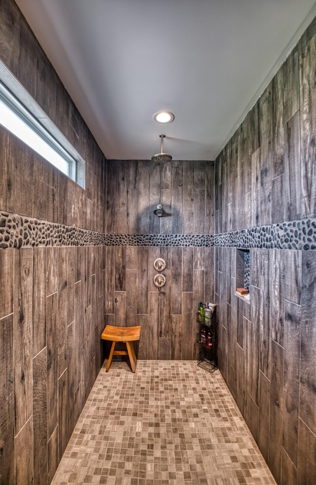 bathroom with a shower and wooden walls