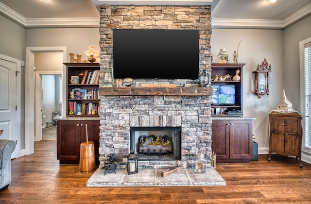 living room featuring a stone fireplace, crown molding, and dark hardwood / wood-style flooring