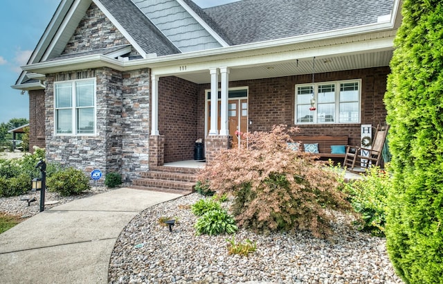 view of exterior entry with covered porch