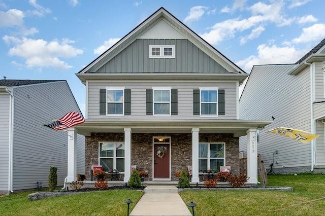 view of front of home with a porch and a front yard