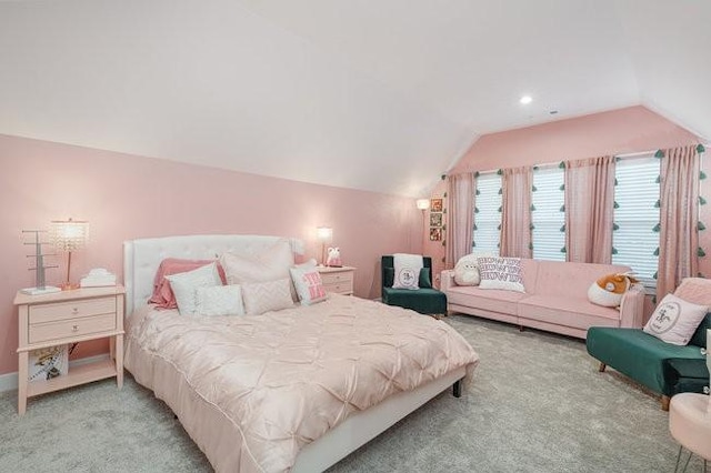 bedroom with light colored carpet and lofted ceiling