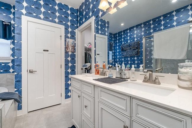 bathroom with tile patterned floors and vanity