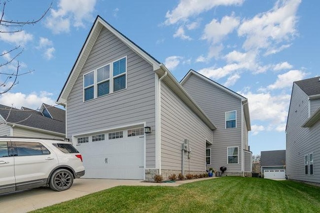 view of side of property with a yard and a garage