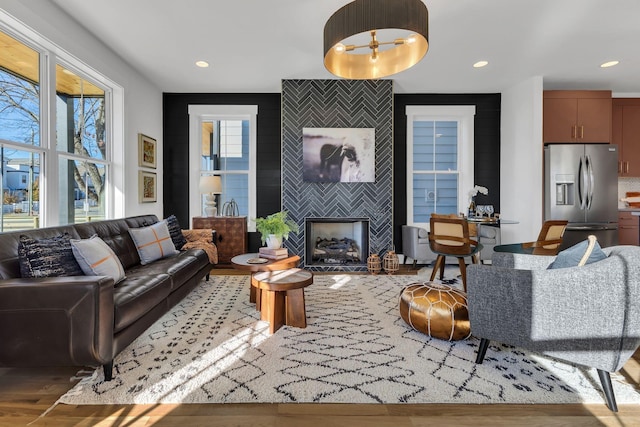 living room with hardwood / wood-style floors and a tile fireplace