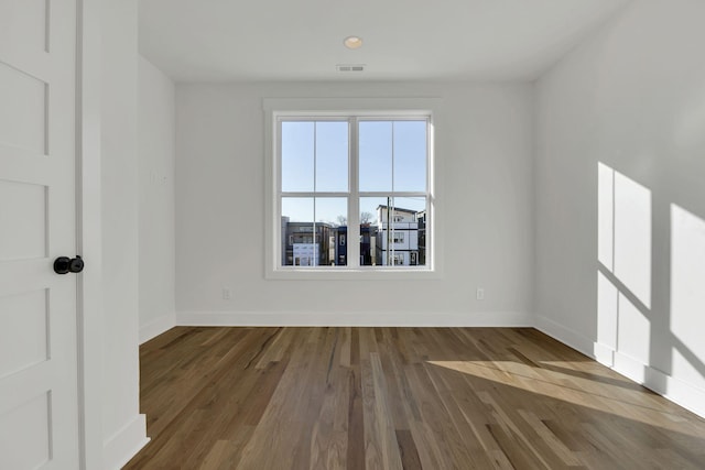 unfurnished room with dark wood-type flooring