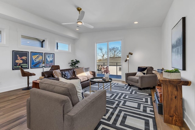 living room featuring ceiling fan, wood-type flooring, and vaulted ceiling