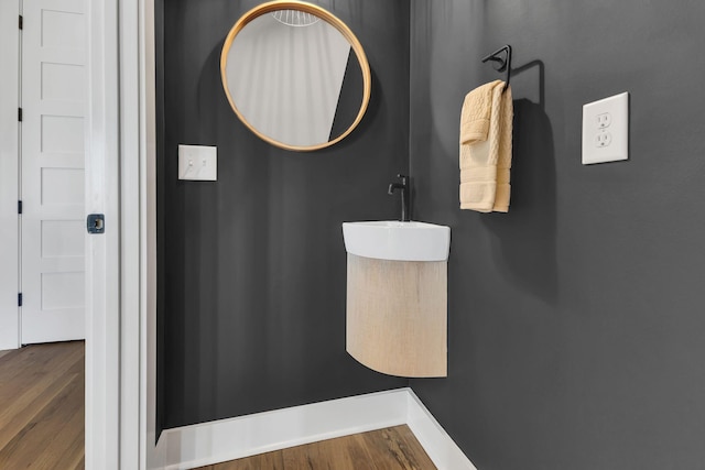 bathroom featuring wood-type flooring and sink