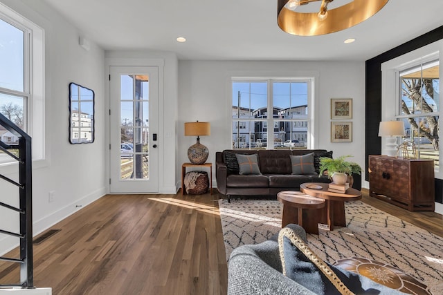 living room featuring dark hardwood / wood-style floors and a wealth of natural light