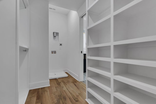 walk in closet featuring hardwood / wood-style flooring