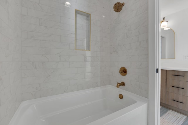 bathroom with vanity and tiled shower / bath