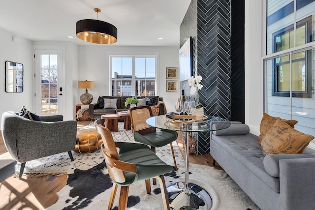 living room featuring hardwood / wood-style floors, a healthy amount of sunlight, and tile walls