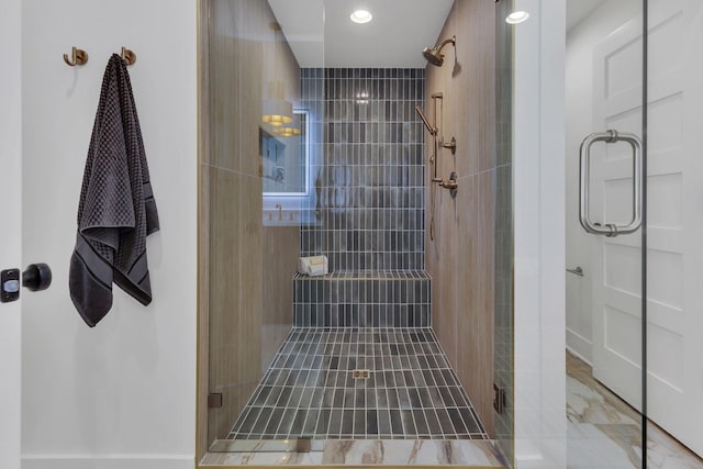 bathroom featuring a shower with door