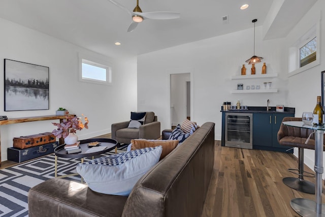 living room featuring wet bar, beverage cooler, dark wood-type flooring, and ceiling fan