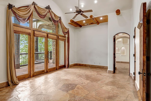 unfurnished room featuring ceiling fan, high vaulted ceiling, and french doors