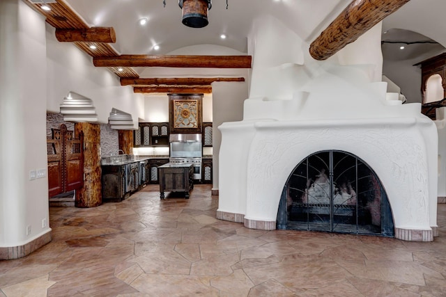 living room with beamed ceiling and a tile fireplace