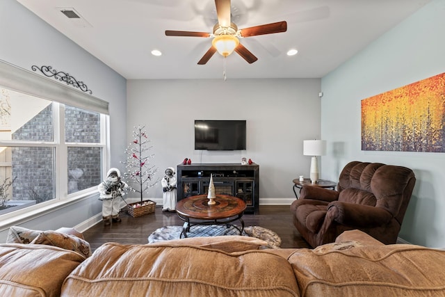 living room with ceiling fan and dark hardwood / wood-style flooring