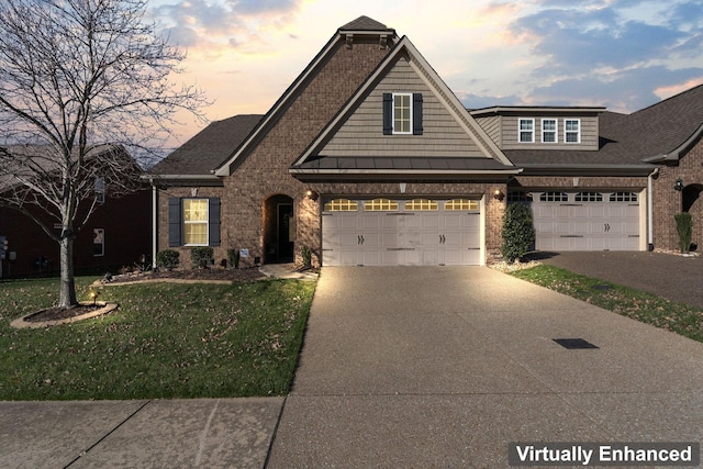 view of front facade featuring a lawn and a garage