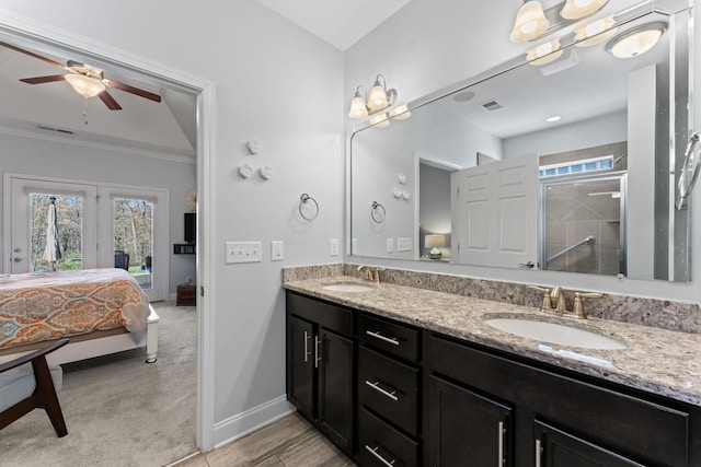 bathroom with vanity, crown molding, ceiling fan, and an enclosed shower