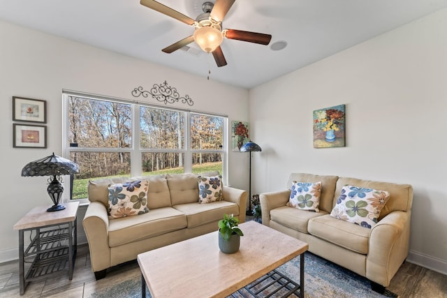 living room featuring ceiling fan and wood-type flooring