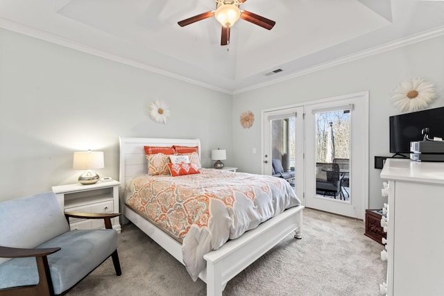 bedroom with light carpet, a raised ceiling, crown molding, ceiling fan, and access to exterior