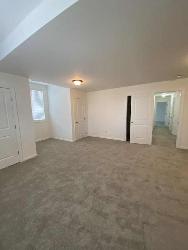 interior space featuring dark colored carpet