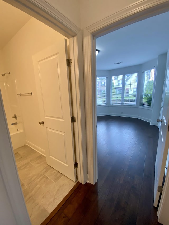 hallway with wood-type flooring